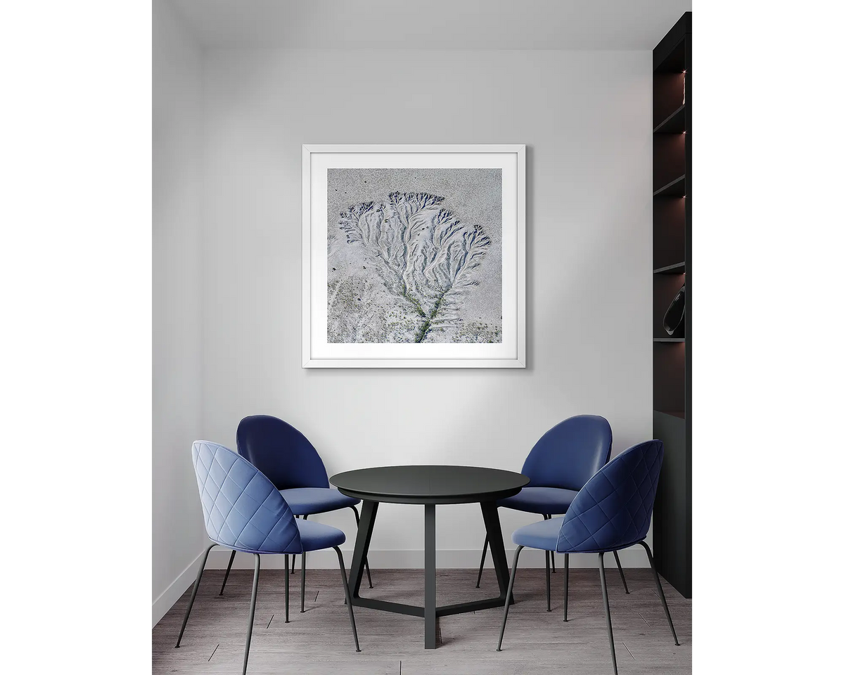 Etched. Tidal patterns, framed wall art print with a white frame, in an office meeting room. 