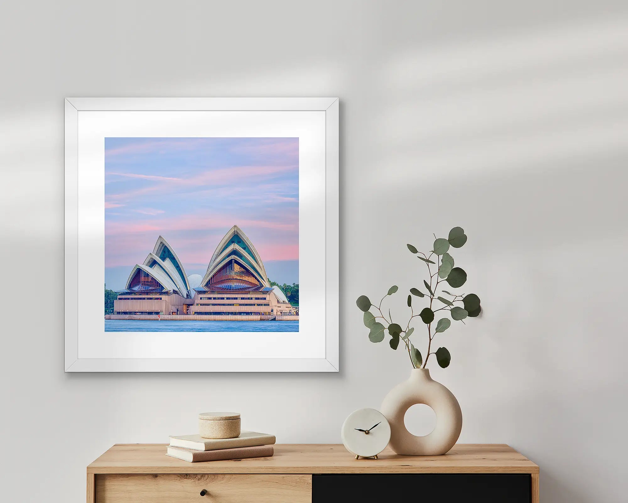 Evening at the opera. Sydney Opera House at sunset with pink sky.