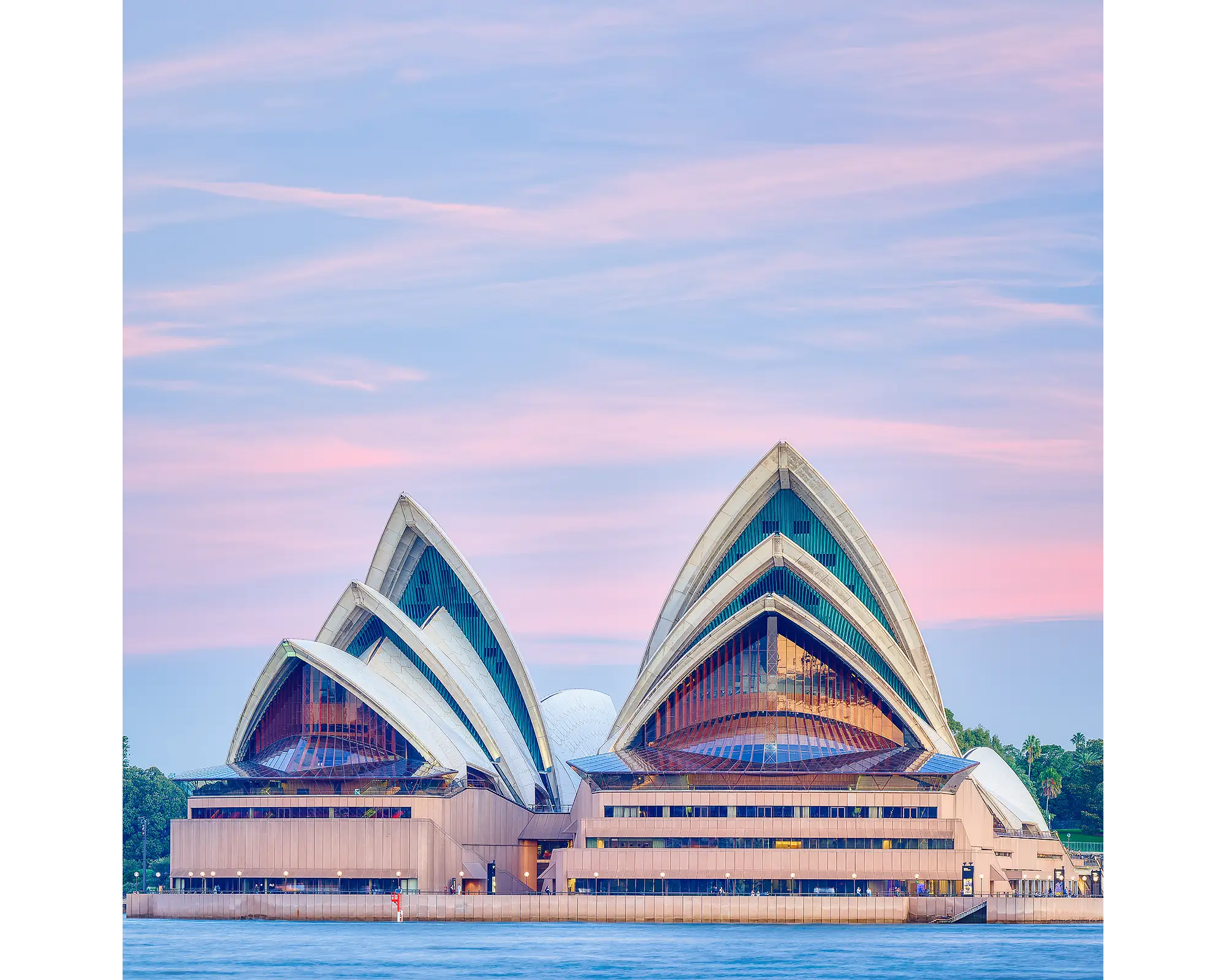 Evening at the opera. Sydney Opera House at sunset with pink sky.