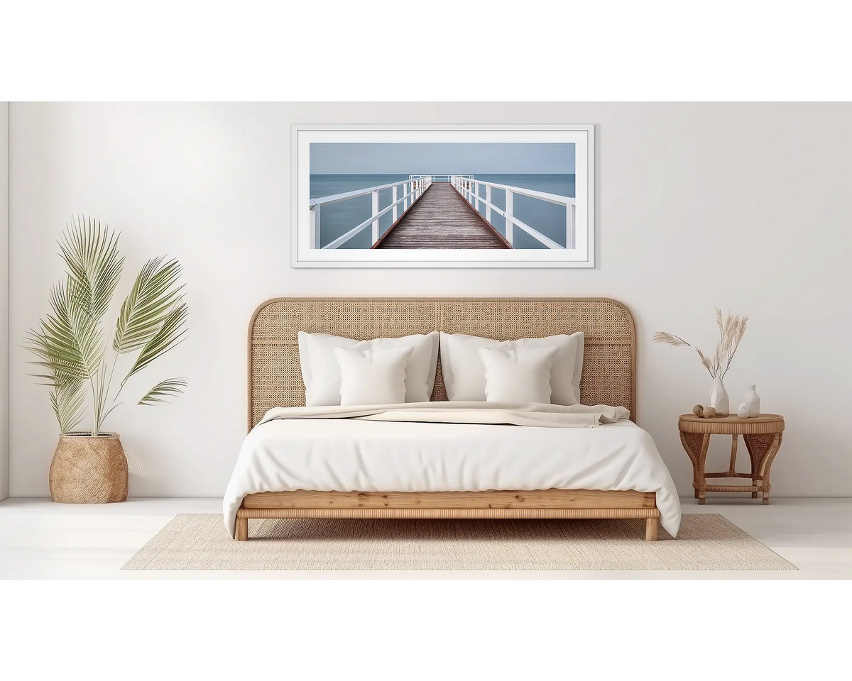 Evening Calm. Hervey Bay wall art, in a white frame, in a bedroom. 