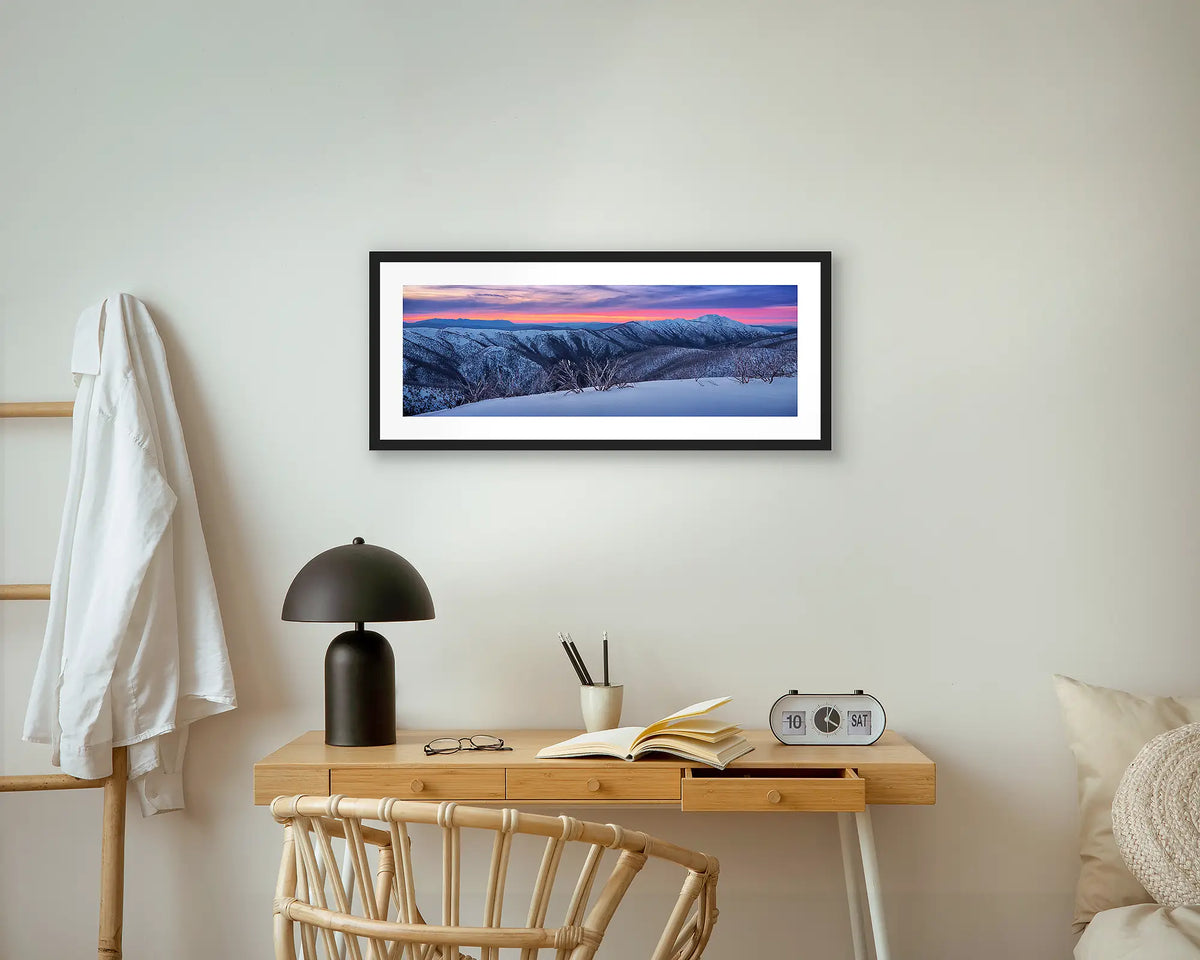 Evening Glory. Winter snow sunset photography, wall art with a black frame, above a bedside table. 