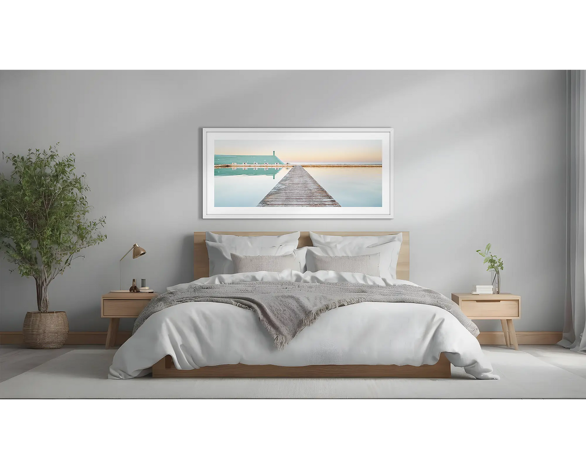 Evening Swim. Newcastle Baths artwork, with a white frame, above a bed. 