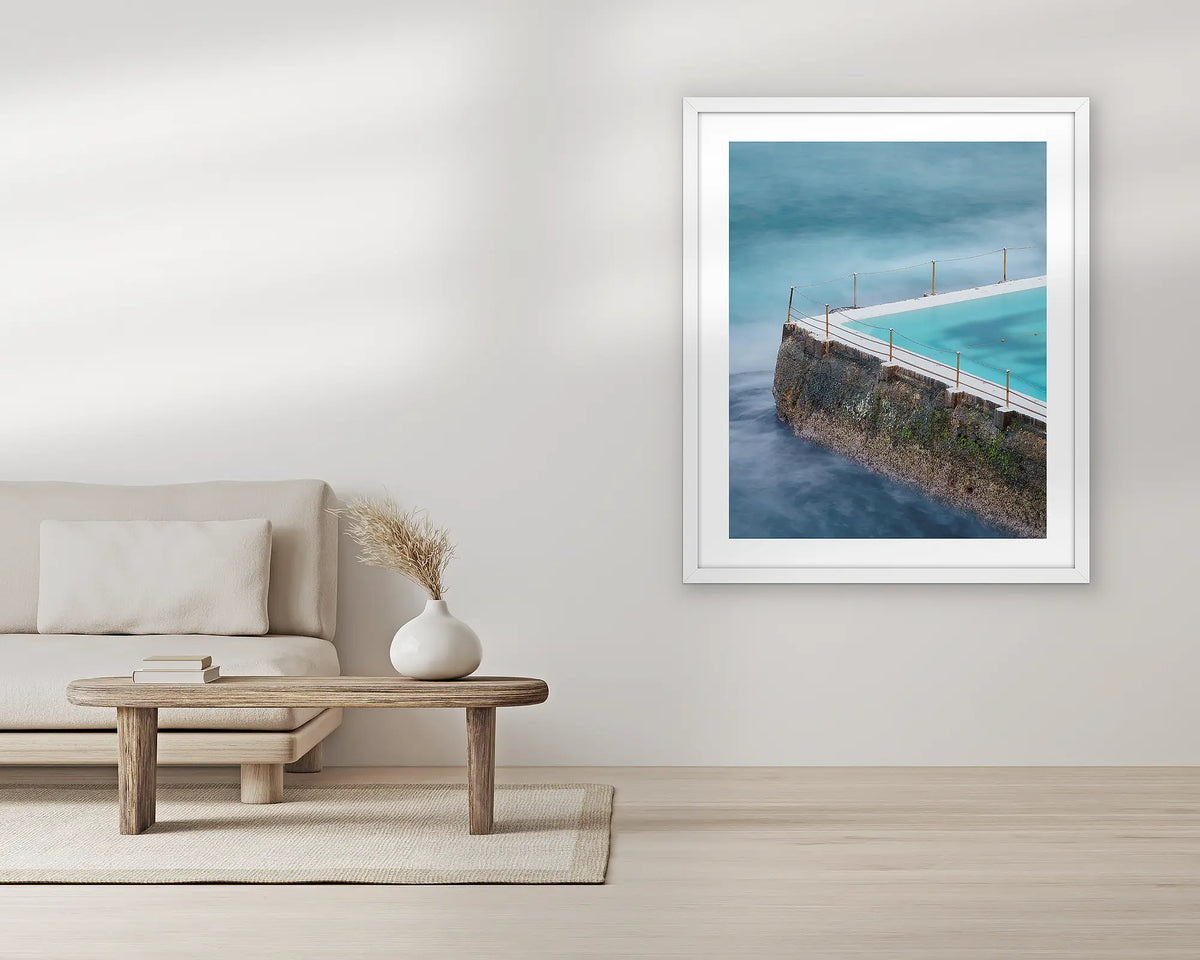 Fenced In. Bondi icebergs wall art print, with a white frame, in a living room. 