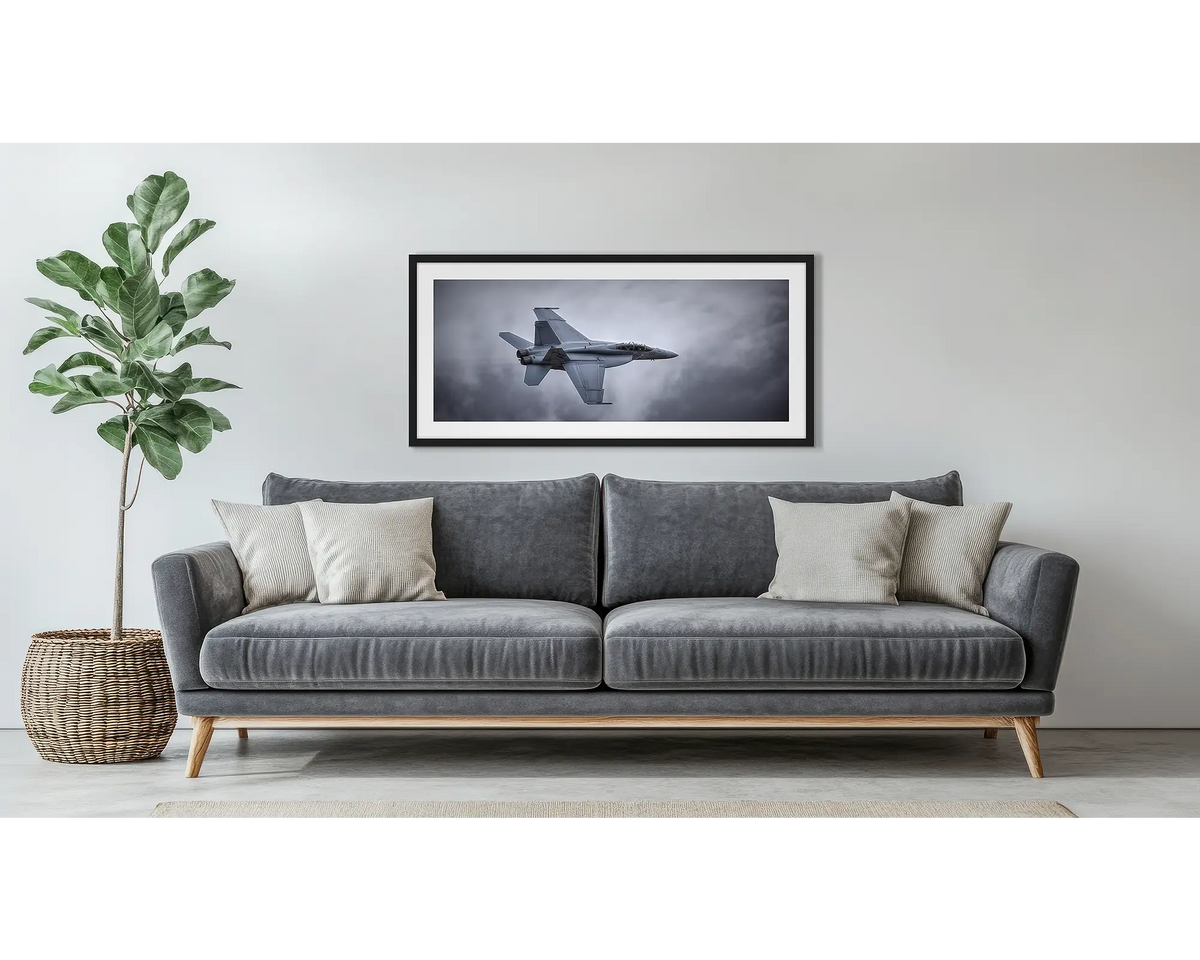 Fighting First. Aviation wall art in a black frame, hung above a couch.