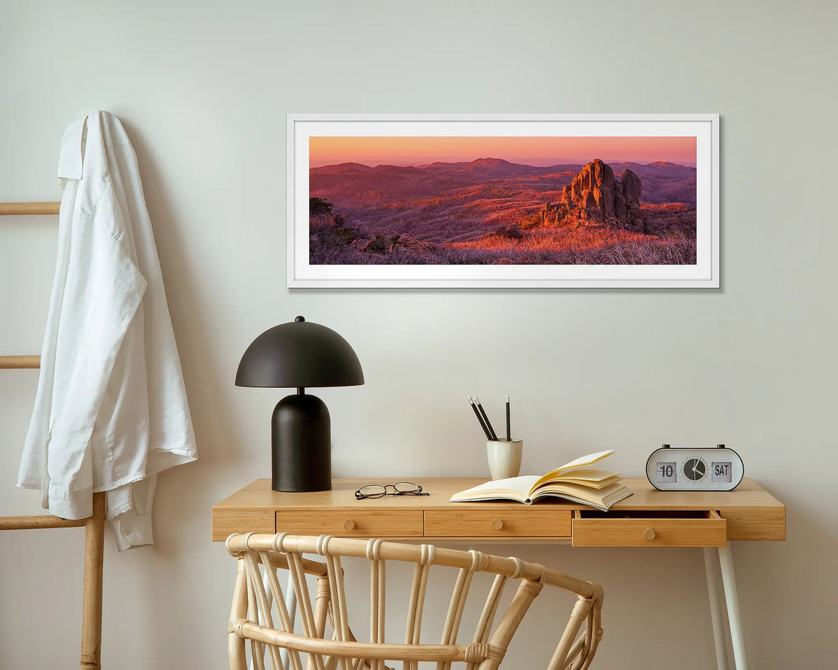 Fire and Rock. The Cathedral, Mount Buffalo wall art print in white frame above small table.