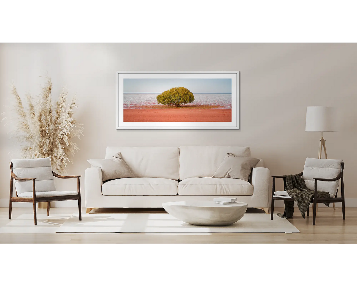 Focus. Broome wall art print, with a white frame, above a couch. 