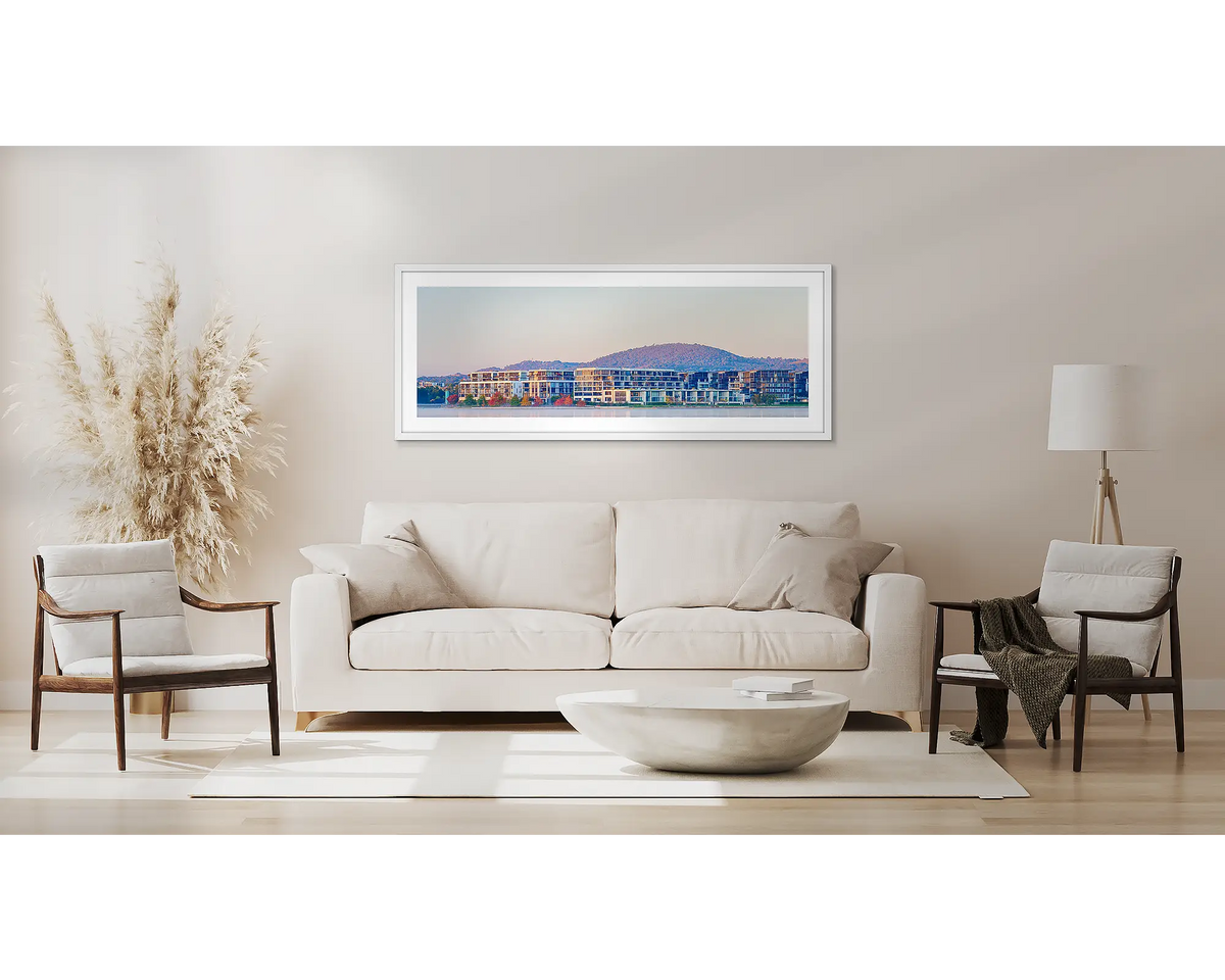 Foreshore Views. Kingston wall art print, in a white frame, above a couch. 