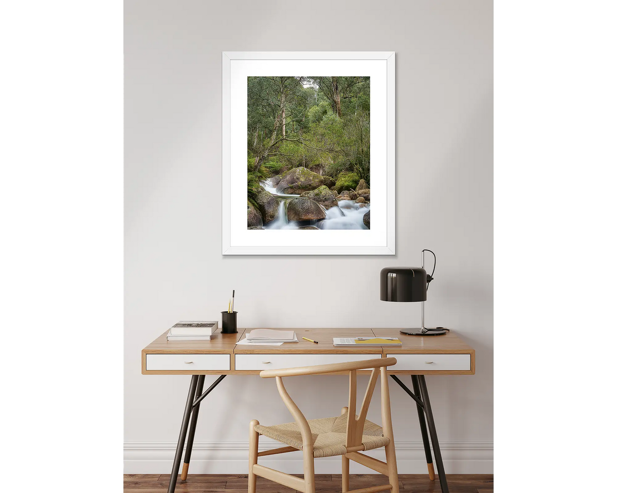 Forest Falls. Mount Buffalo wall art print with a white frame, hanging above a desk.