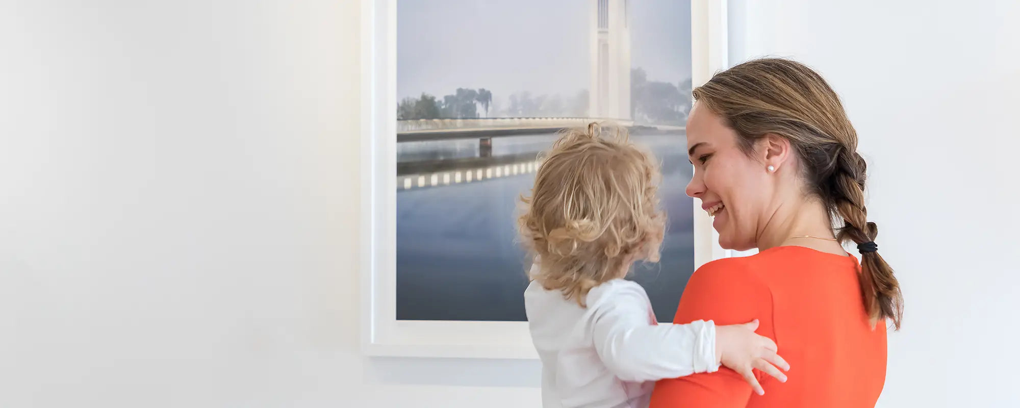 Gifts For Her. Mum and baby looking at wall art.