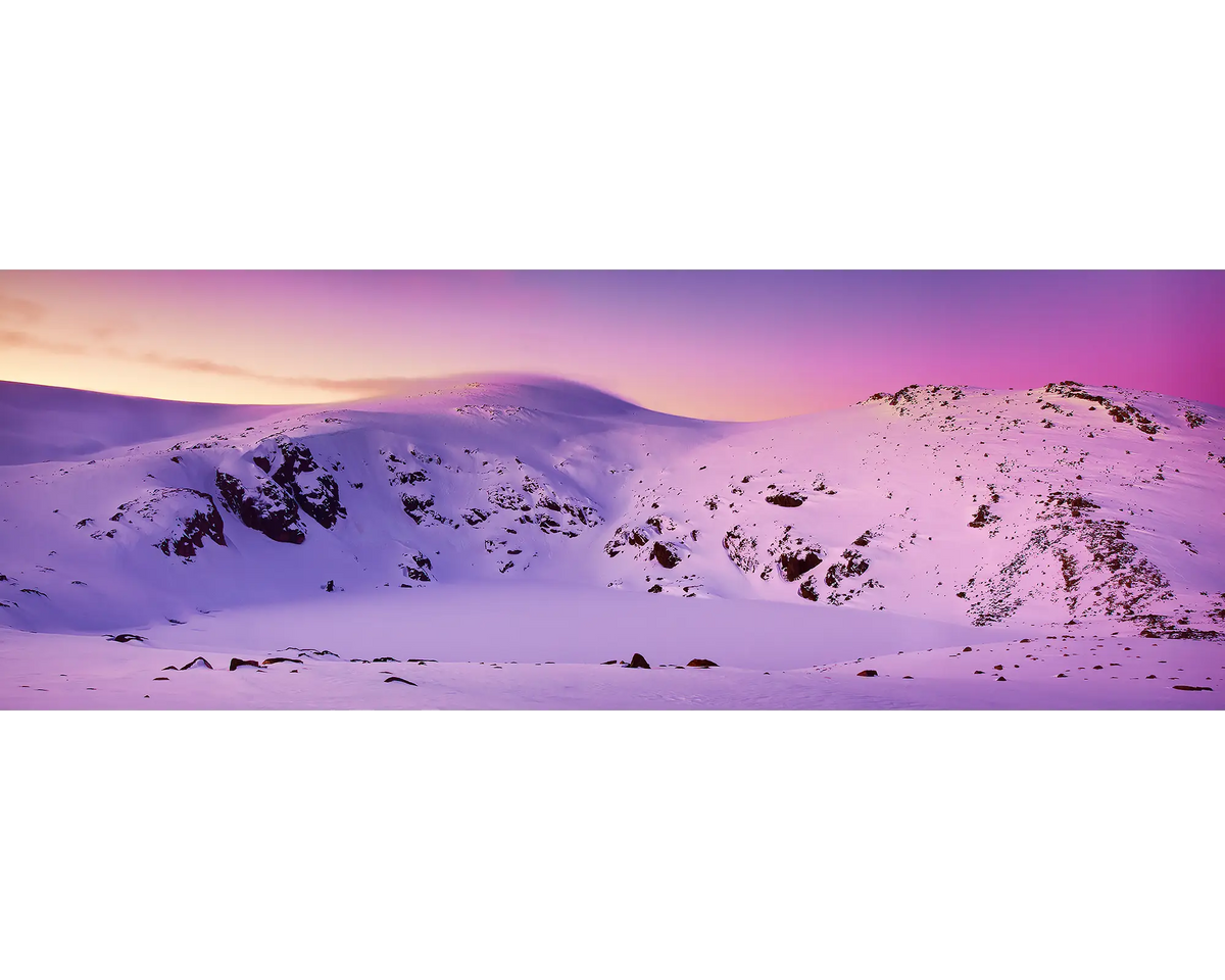 Sunset over Blue Lake frozen over and covered in snow, Kosciuszko National Park, NSW. 