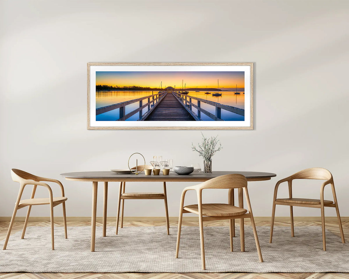 Golden Morning. Batemans Bay jetty, framed wall art with a Tassie oak frame, on a dining room wall. 