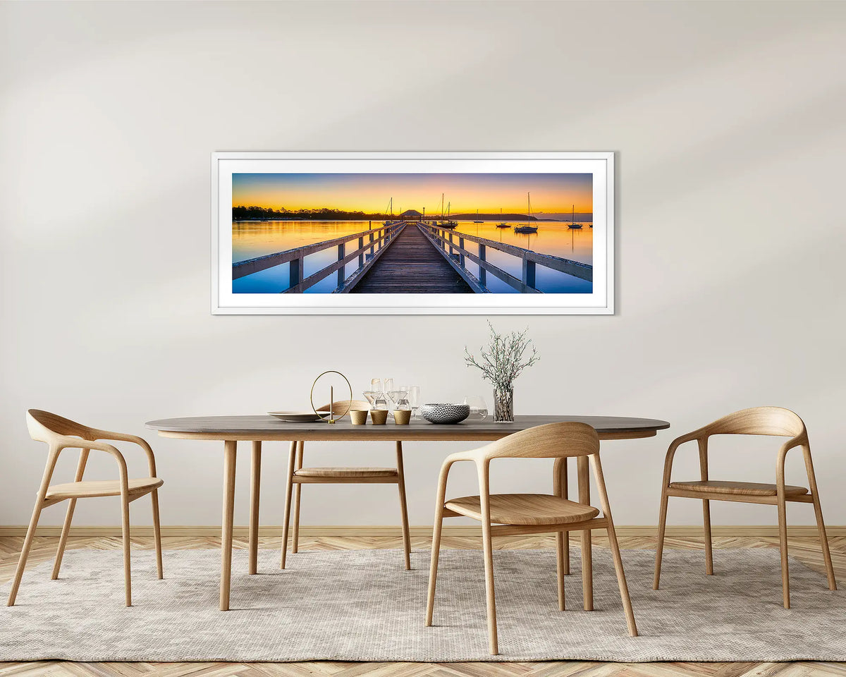 Golden Morning. Batemans Bay jetty, framed wall art with a white frame, on a dining room wall. 