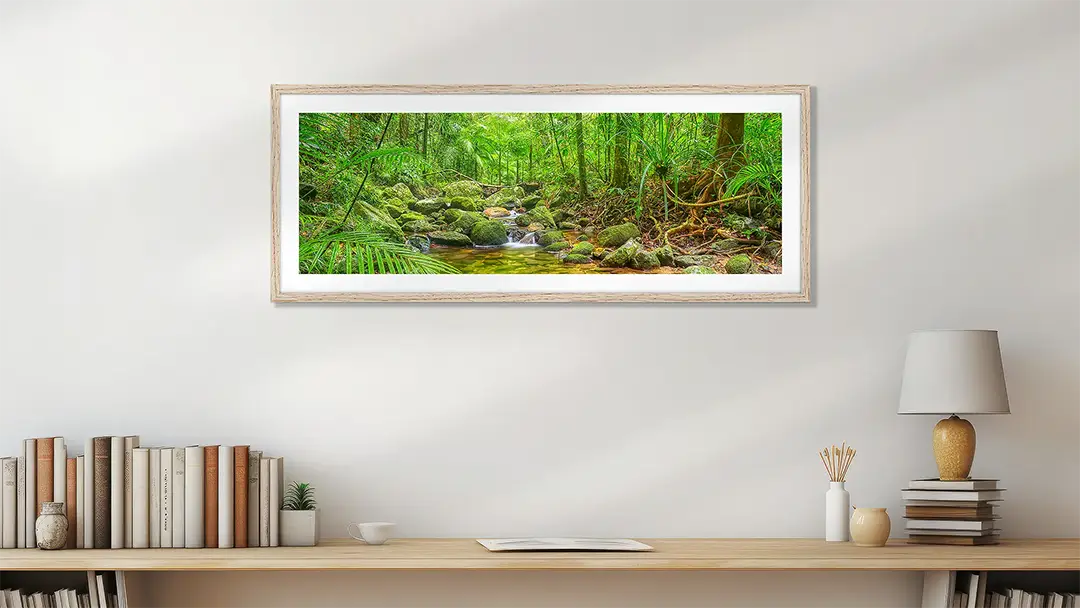 Green wall art print with wood frame on study wall.