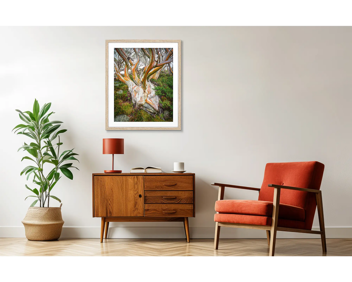 Heart of the Alps. Snow Gum artwork in a wood frame above a side table. 