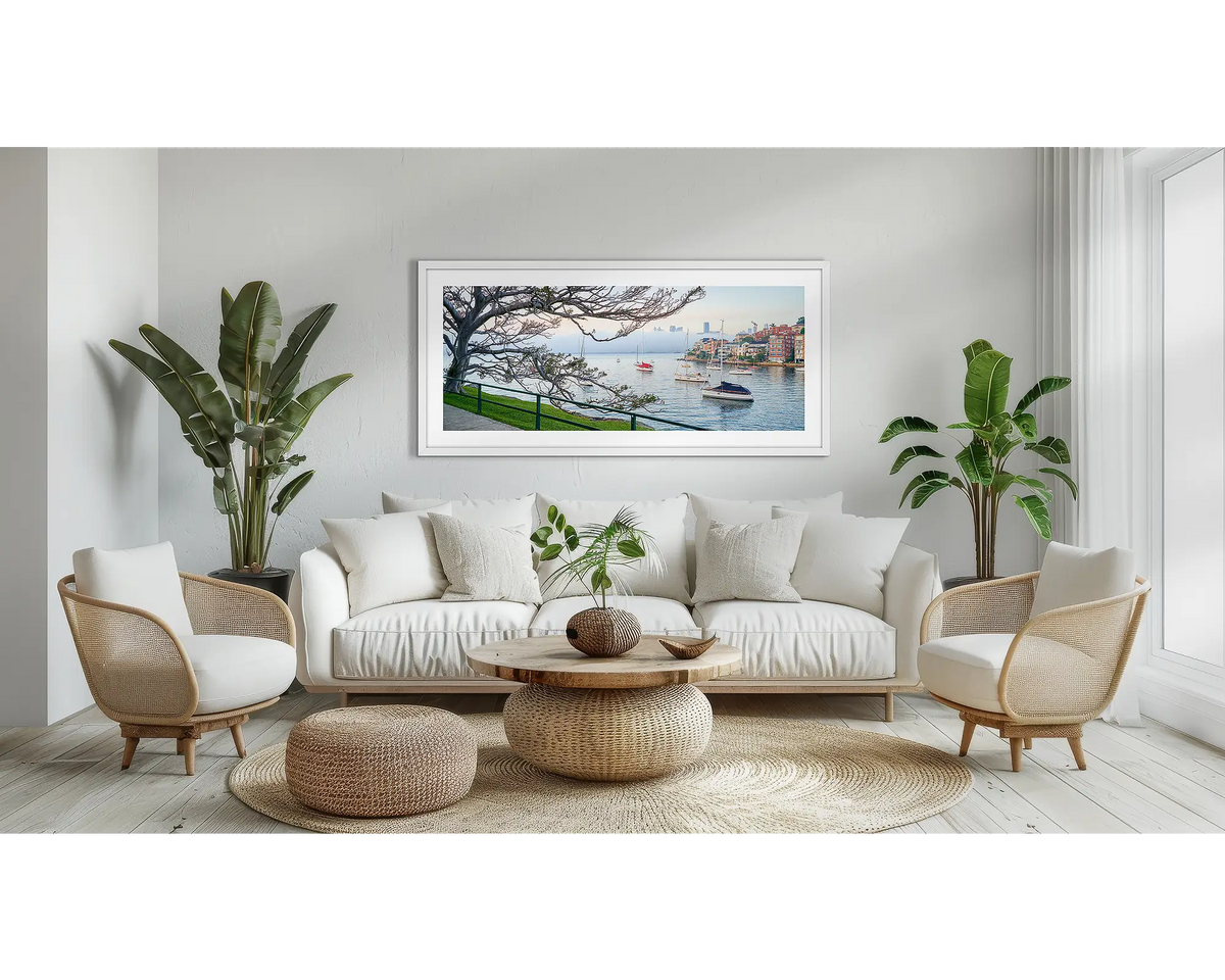 Hidden. Sydney Harbour wall art, in a white frame, in a lounge room. 