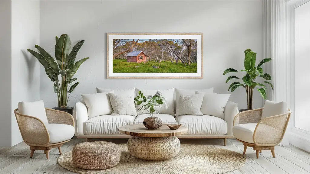 High Country Hut wall art print with timber frame above couch.