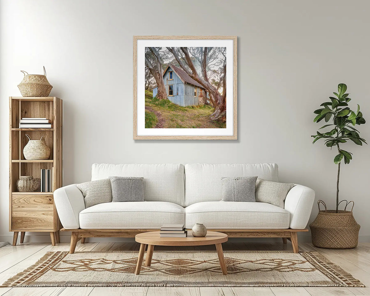 High Country Life. Hut wall art print, with a timber frame, in a lounge room. 