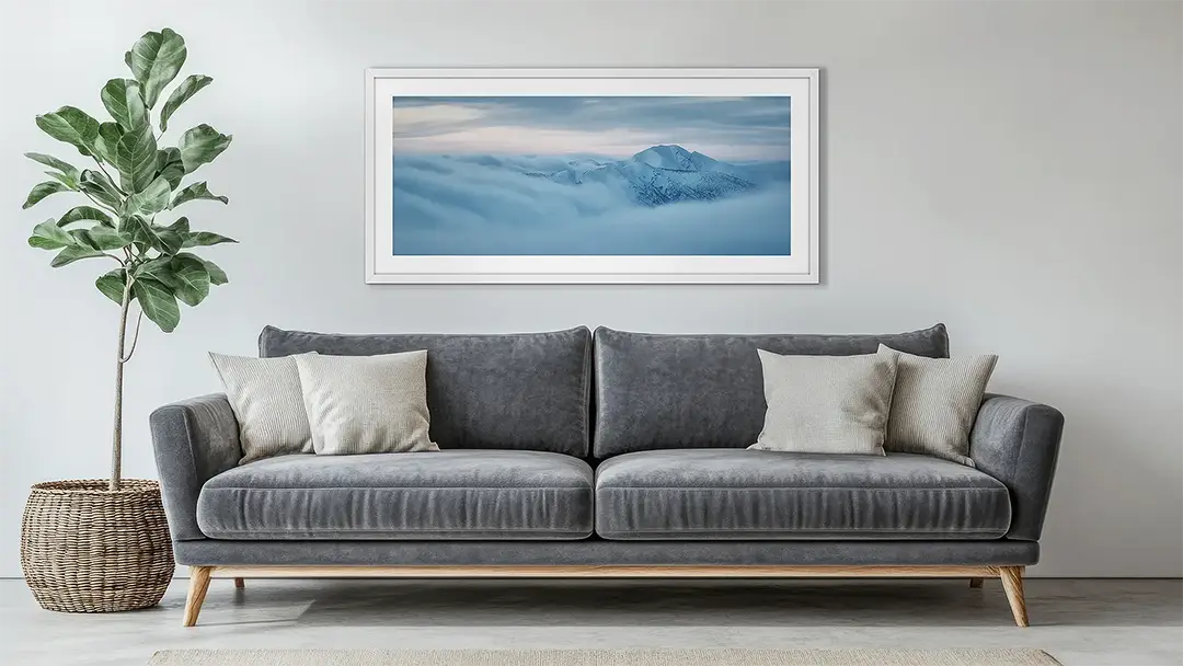 Horizontal Panoramic wall art print with white frame hung above couch.