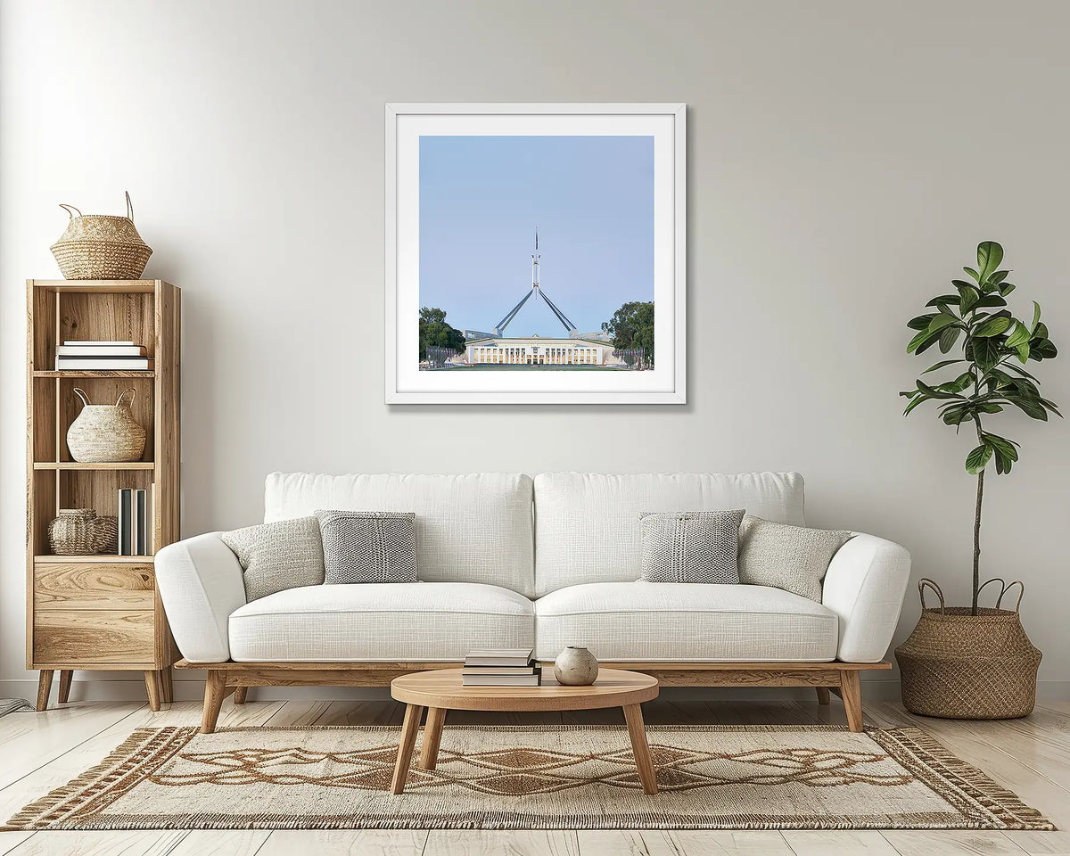 House on the Hill. Parliament House Canberra wall art print, with a white frame, in a lounge room. 