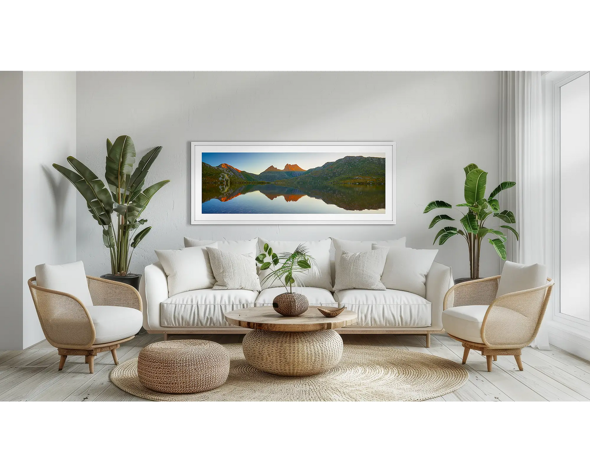 Illumination. Tasmanian wilderness wall art print, in a white frame, above a couch. 