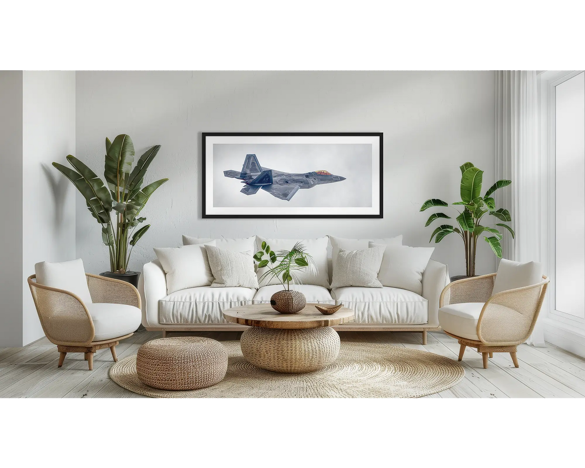 Inbound. F-22 Raptor aviation wall art print, with a black frame, above a couch. 