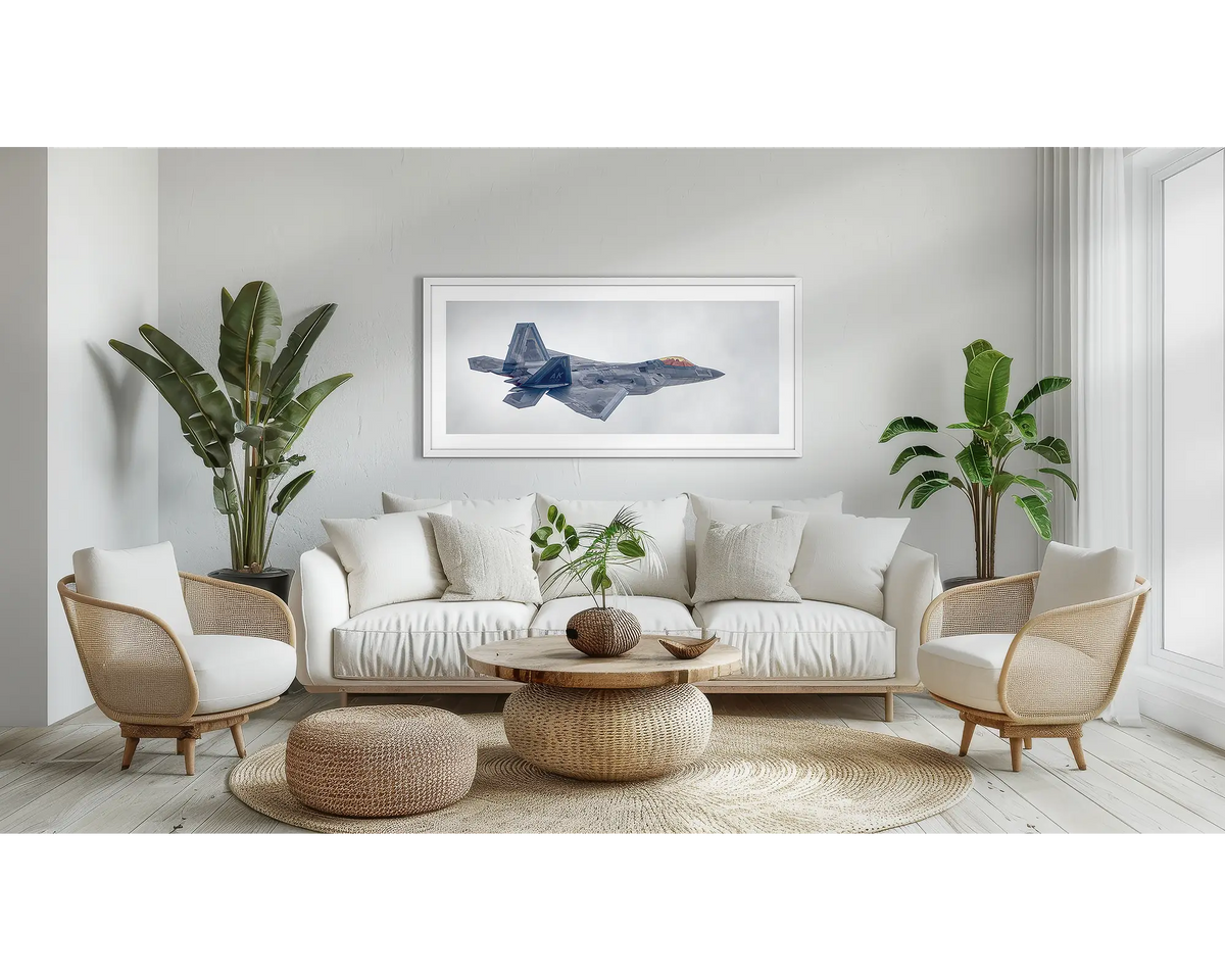 Inbound. F-22 Raptor aviation wall art print, with a white frame, above a couch. 