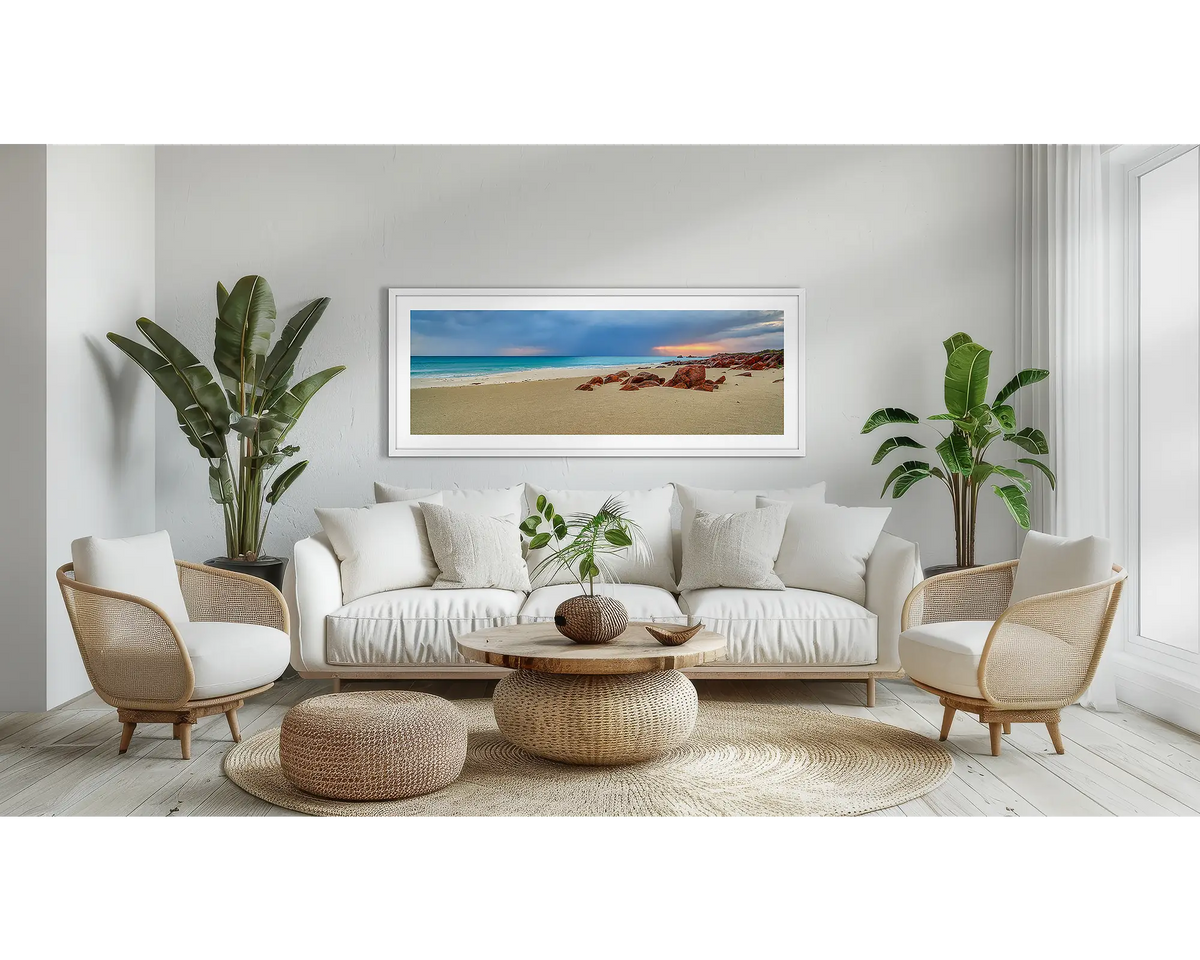 Incoming. Coastal wall art print, with a white frame, above a couch. 