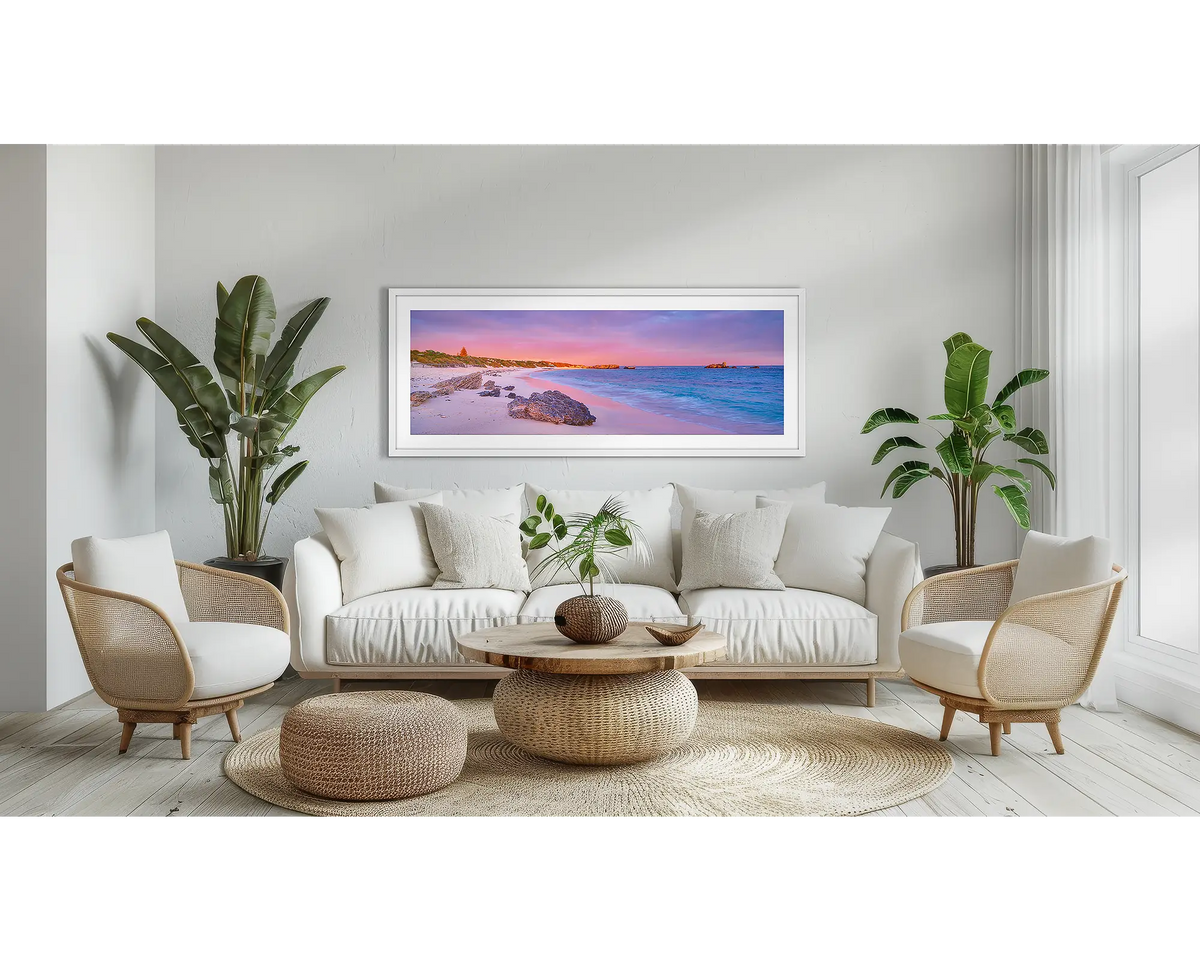 Island Getaway. Coastal wall art print, with a white frame, above a couch. 