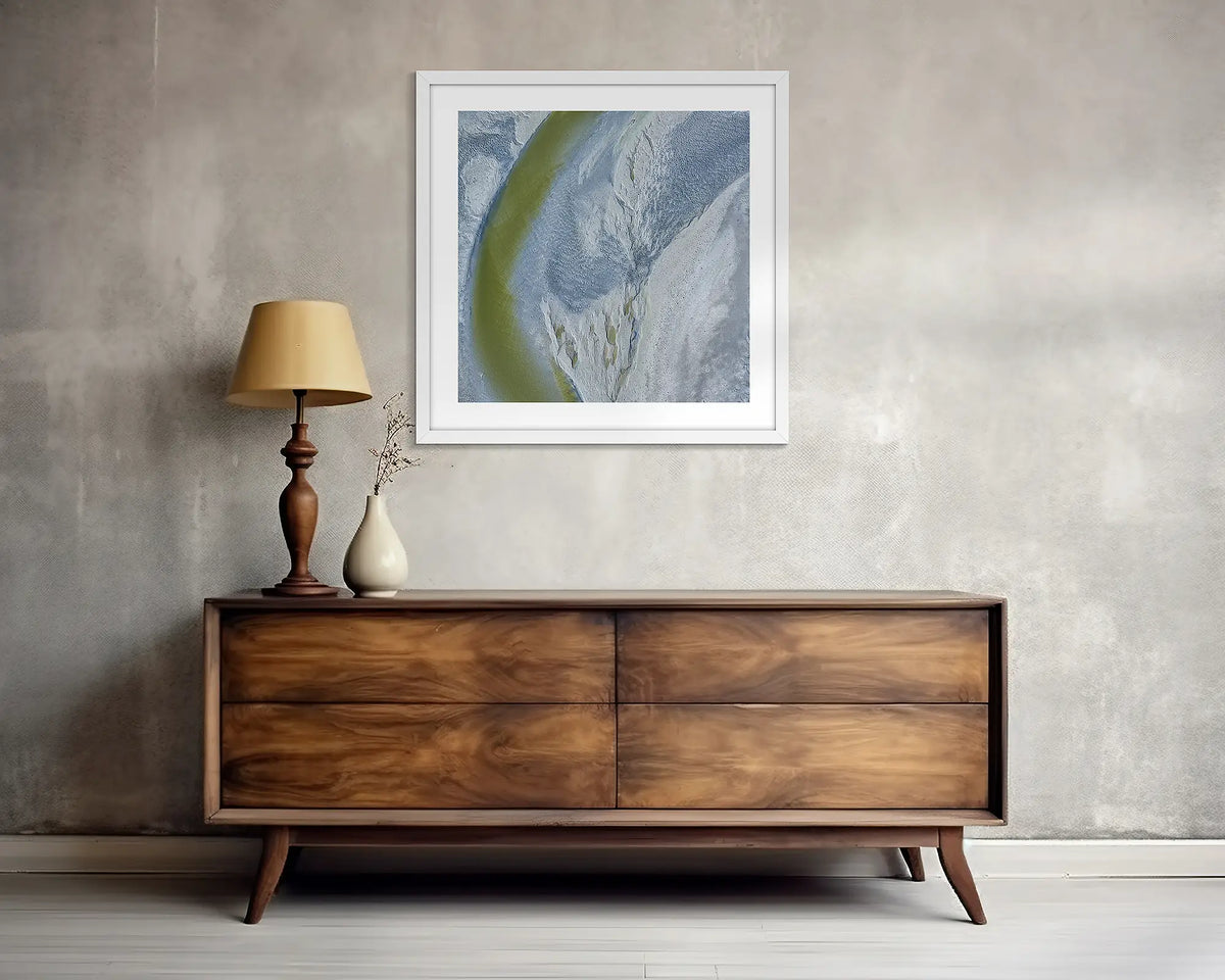 Journey To The Sea. Abstract Kimberley wall art print with white frame, above a side table.