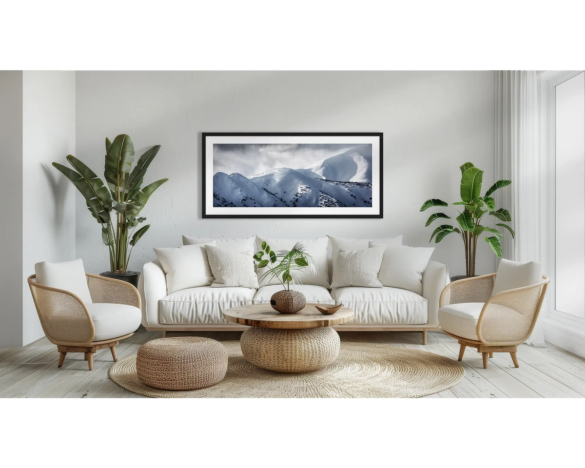 Journey to the Summit. Alpine wall art print, with a black frame, above a couch. 