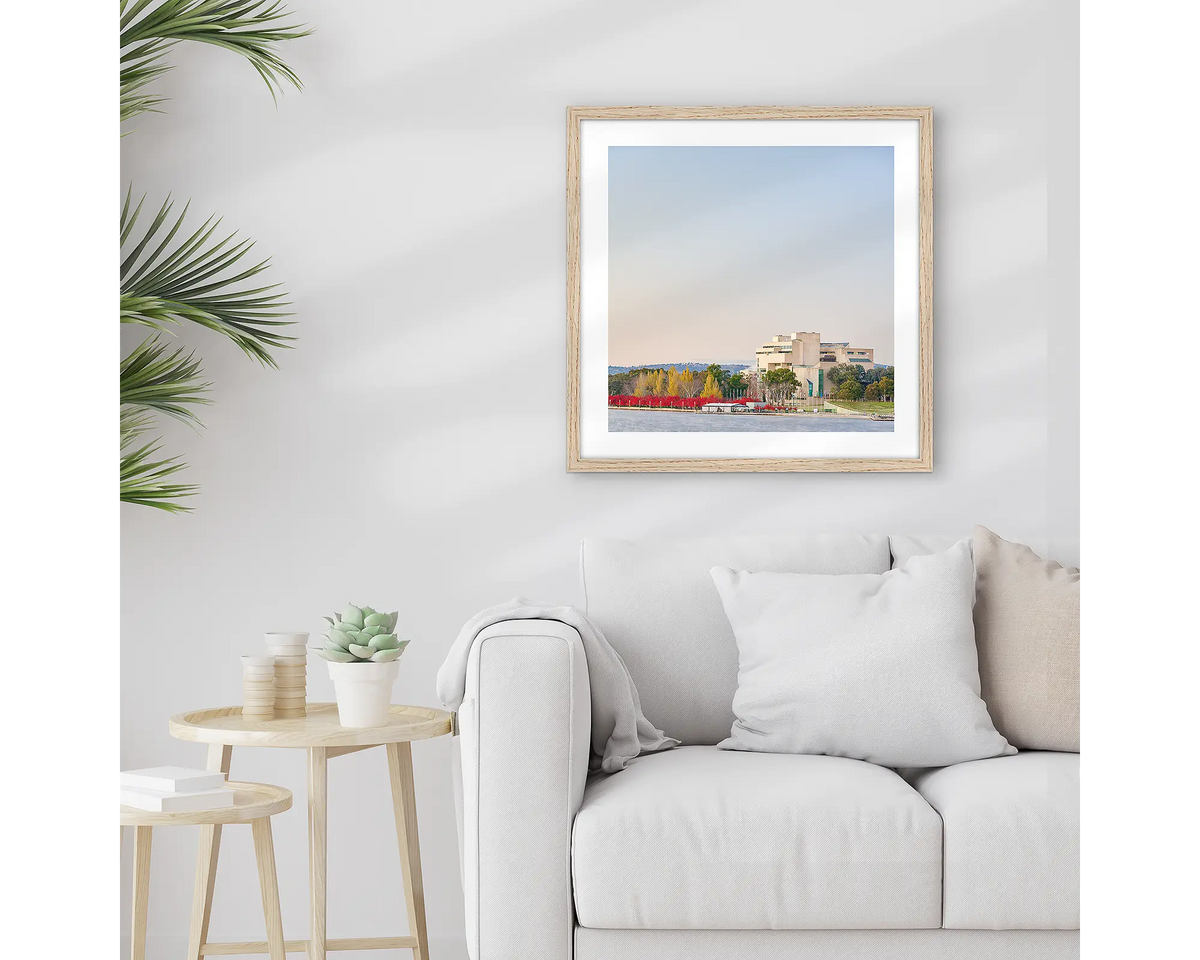 Entry. Framed High Court of Canberra wall art print, with a Tasmanian Oak frame, hung above a couch.