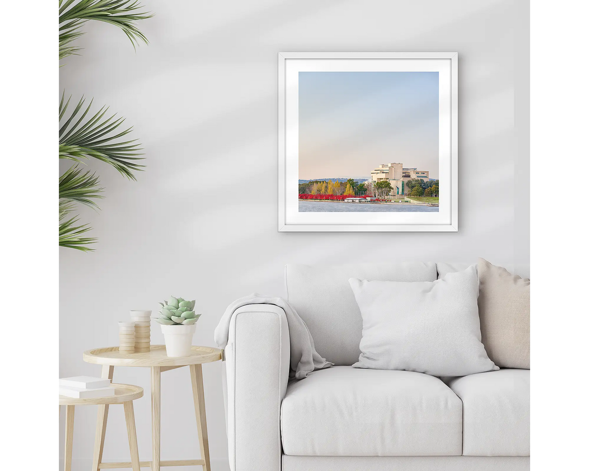 Lake Lookout. Framed High Court of Canberra wall art print, with a white frame, hung above a couch.