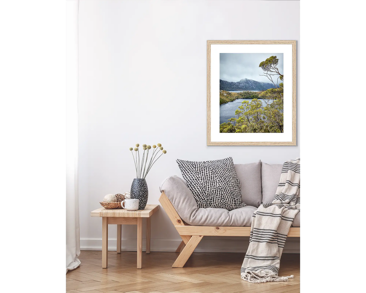 Lake View. Tasmanian wall art print in a Tasmanian Oak frame, hanging above a couch.