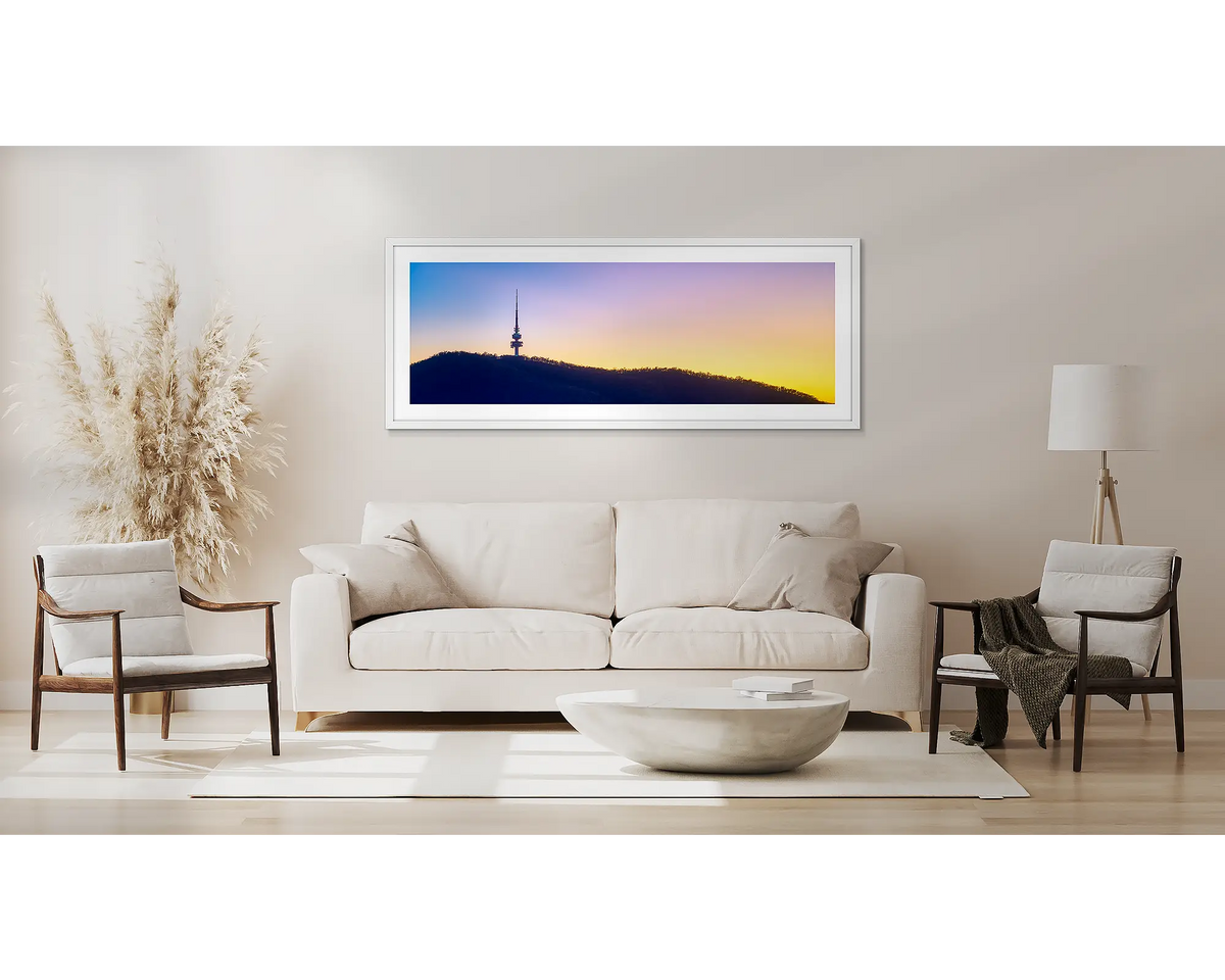 Landmark. Black Mountain Tower artwork in a white frame, above a couch. 