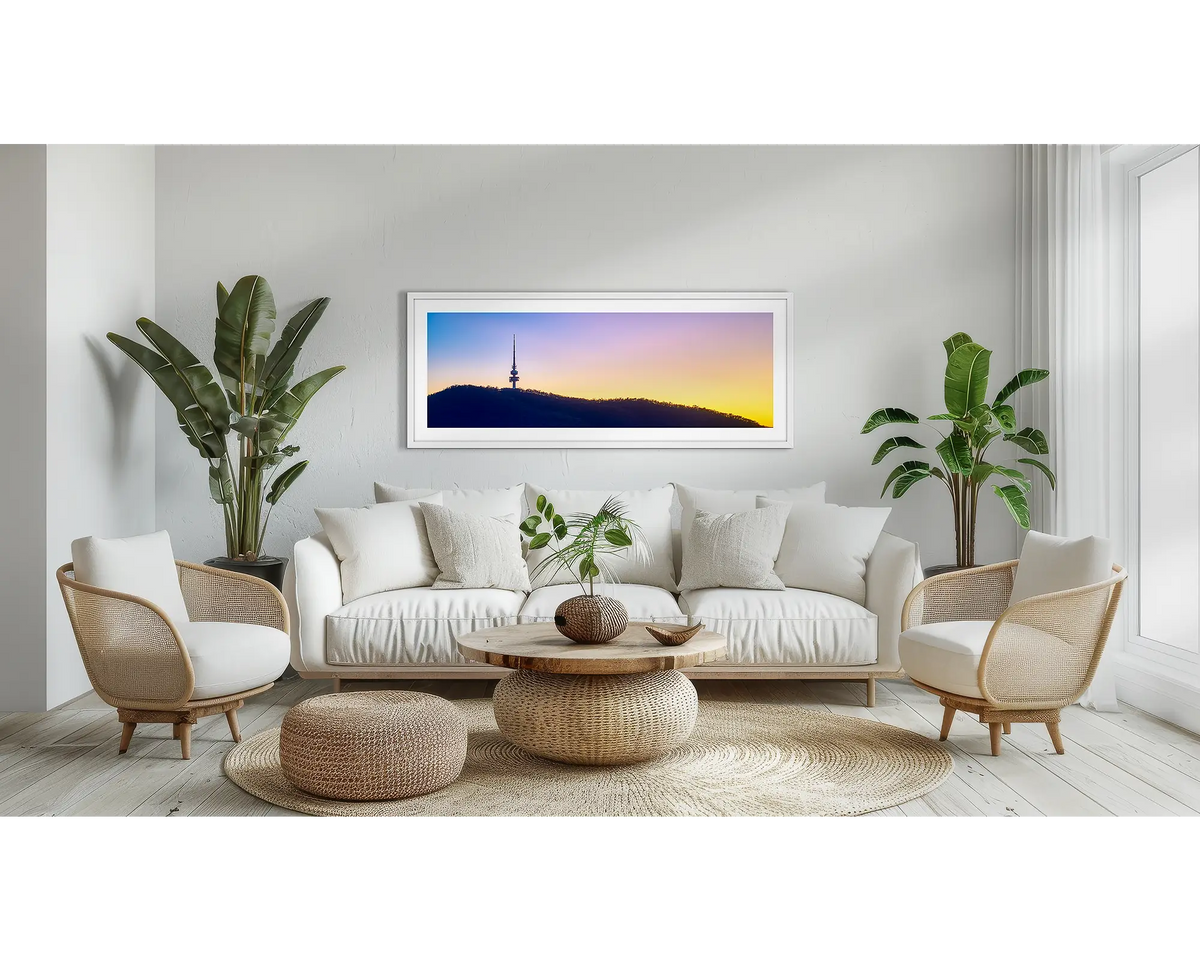 Landmark. Black Mountain Tower wall art print, with a white frame, above a couch. 