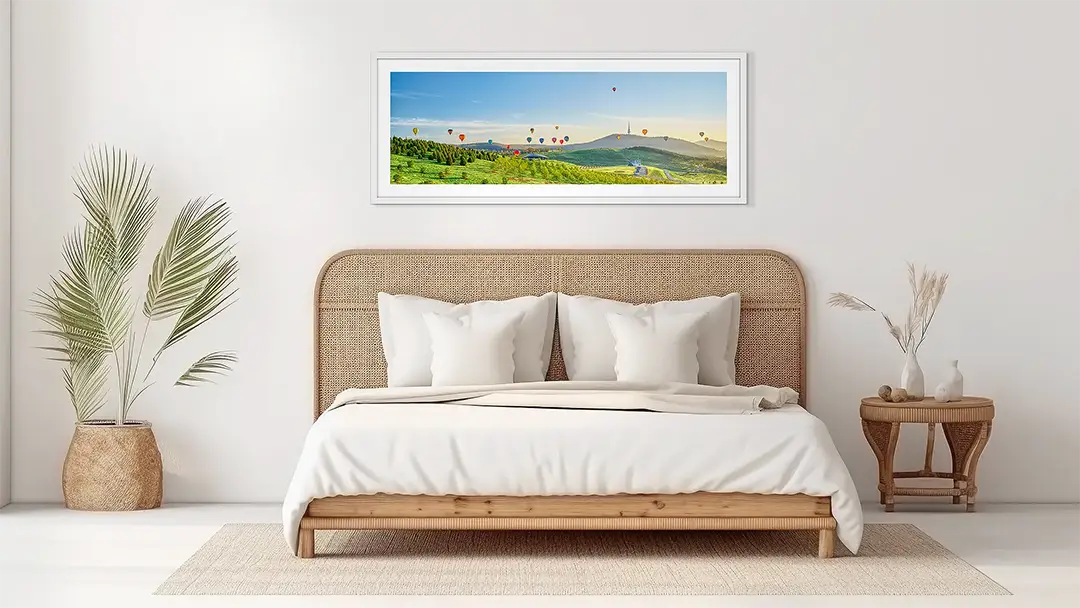 Landscape wall art artwork in white frame in bedroom.