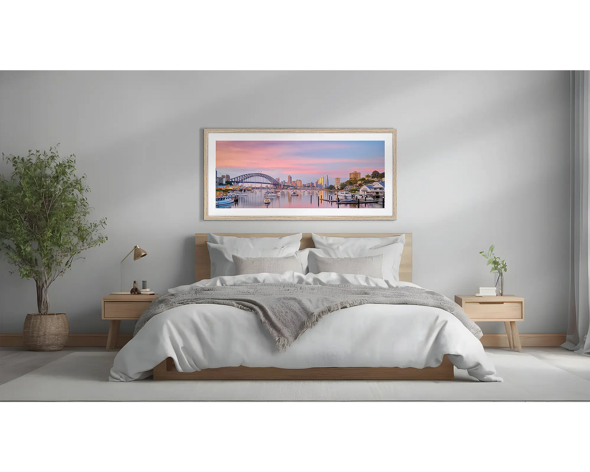 Lavender Sunrise. Sydney artwork in a Tasmanian oak frame, above a bed. 