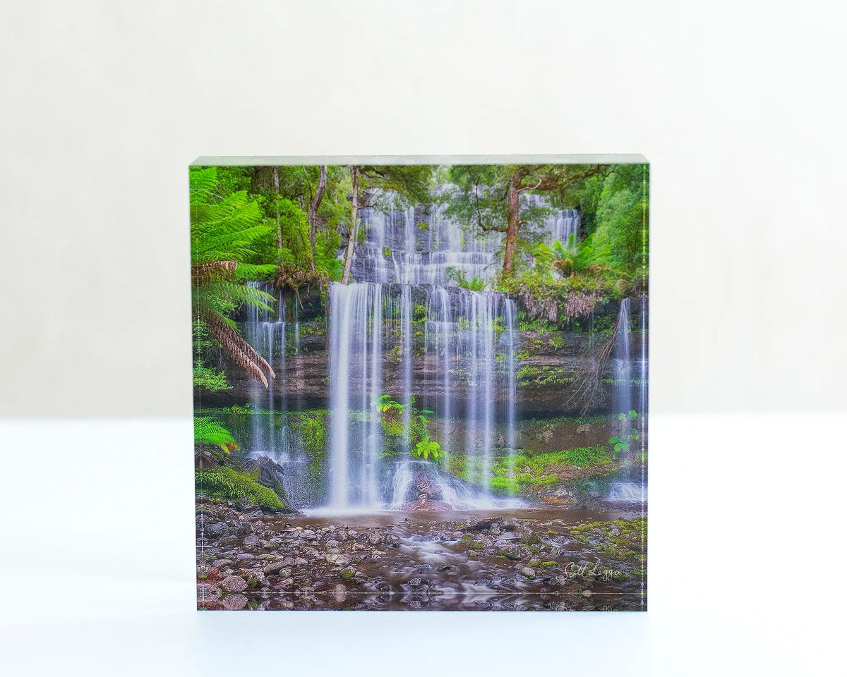 Layers Tasmanian waterfall acrylic block displayed on a desk. 