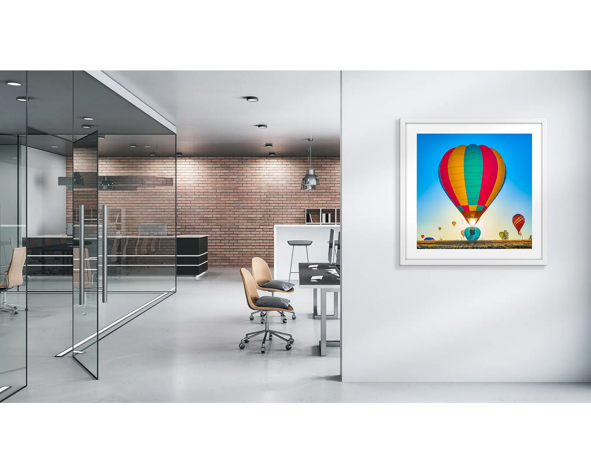 Lift. Canberra balloons wall art print, with a white frame, in a modern office. 