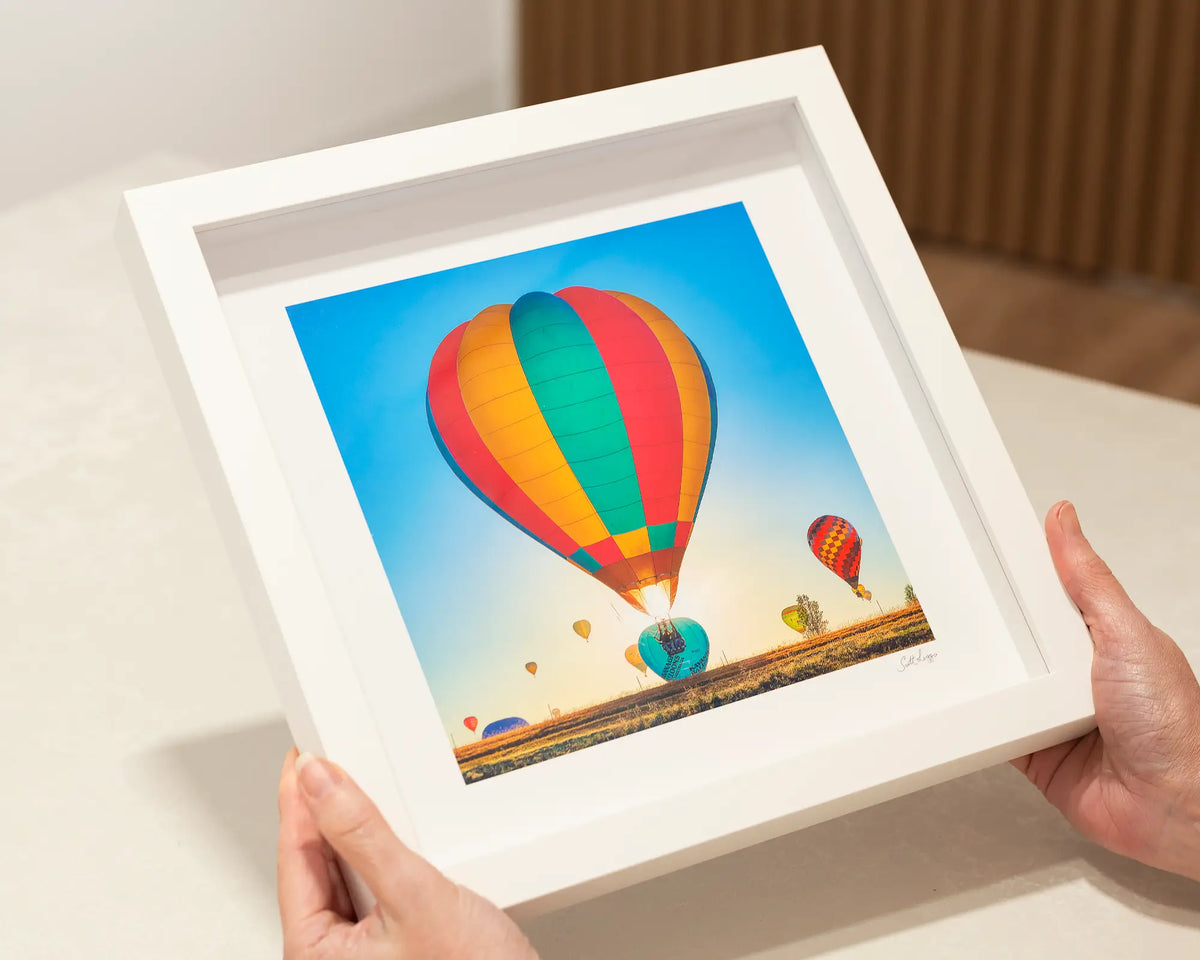 Lift. Enlighten, Balloon spectacular small framed print, in a white frame.