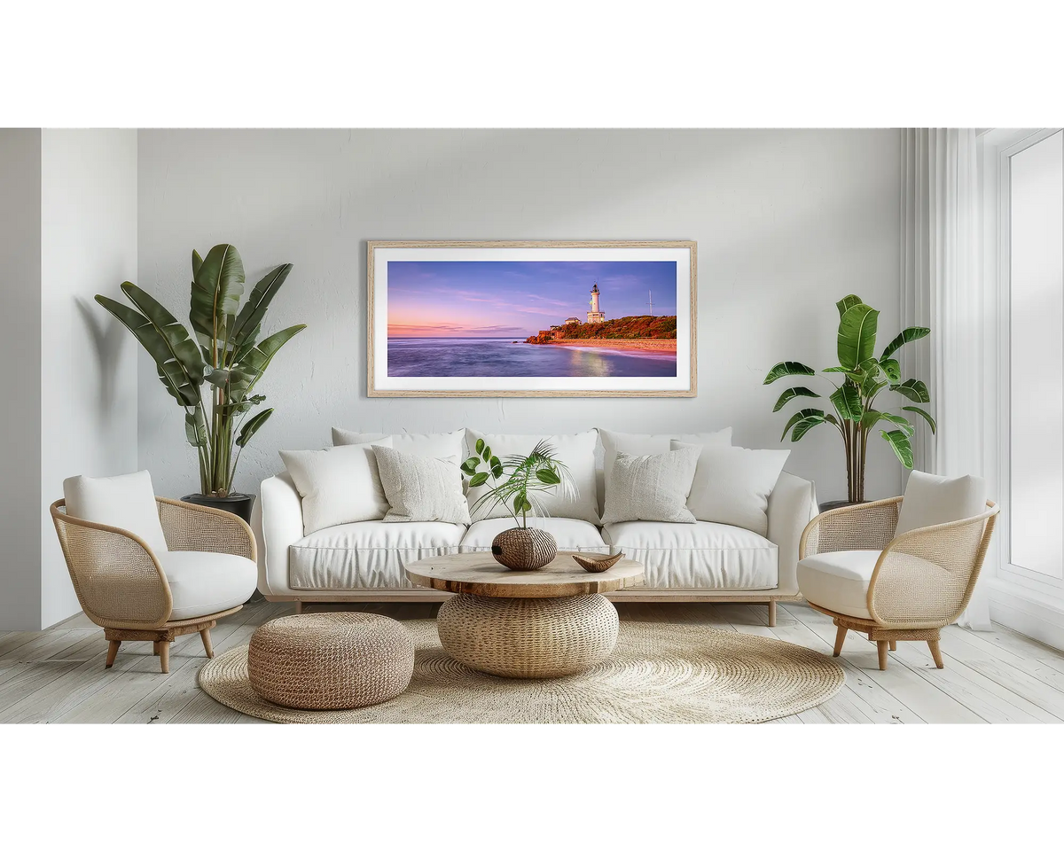 Light Me Up. Point Lonsdale wall art print, with a Tassie oak frame, above a couch. 