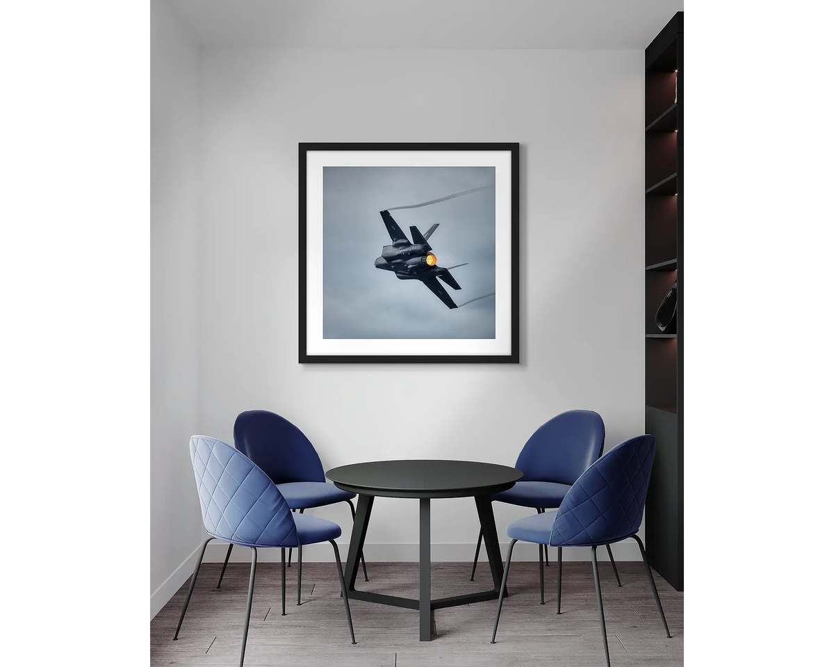 Lit. F-35 aviation, wall art print with a black frame, in an office meeting room. 