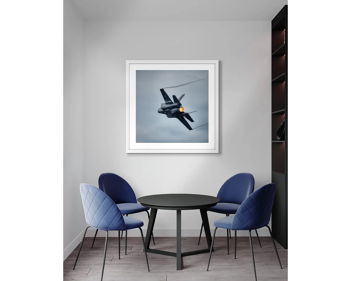 Lit. F-35 aviation, wall art print with a white frame, in an office meeting room. 