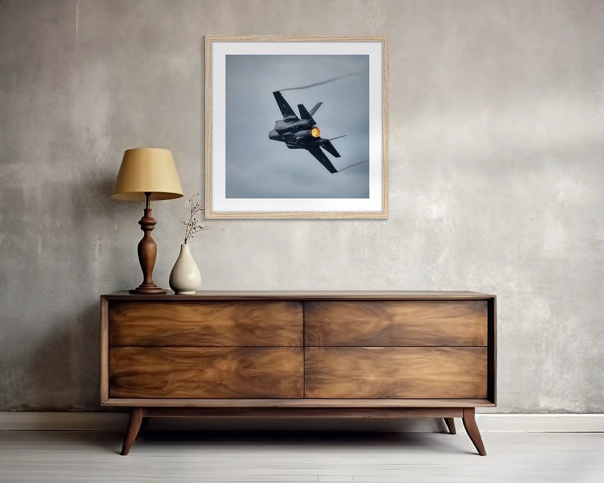 Lit. F-35 jsf wall art print, with a wood frame, above a side table. 