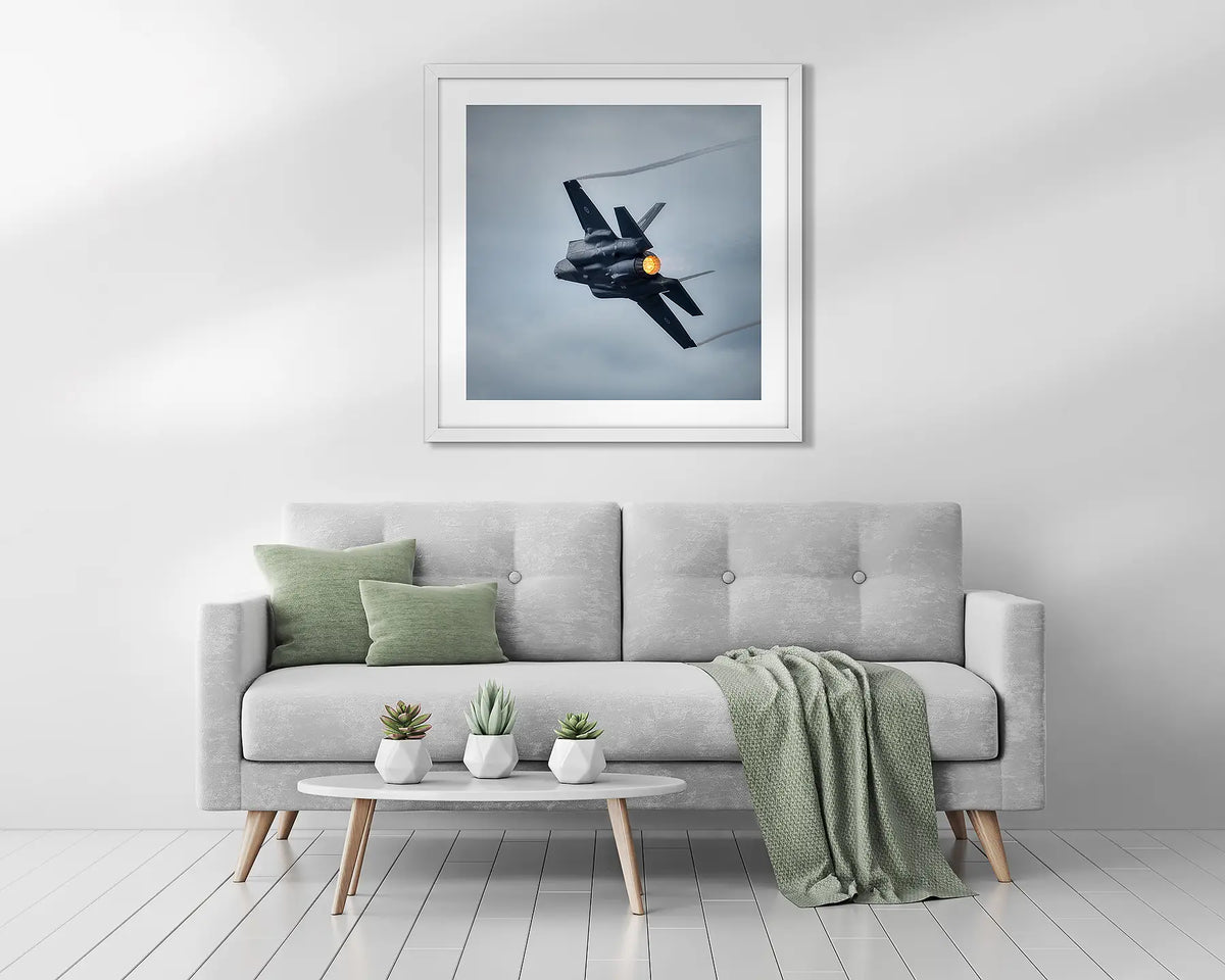 Lit. Framed aviation wall art above a couch. 