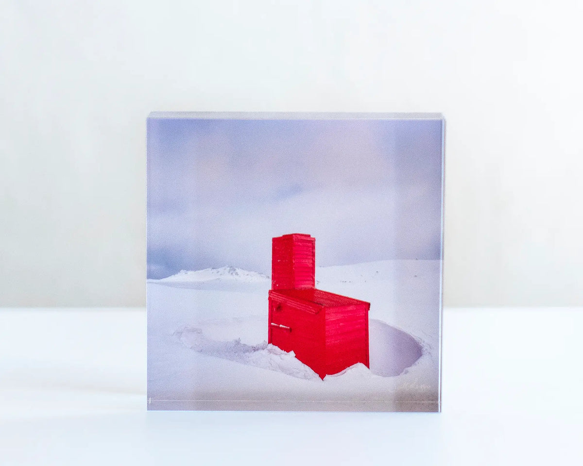 Little Red acrylic block displayed on a desk. 