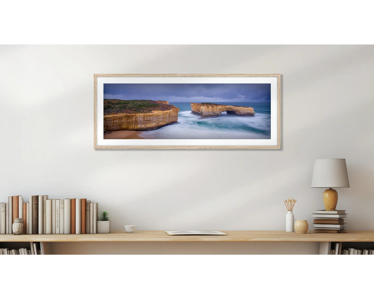 London Bridge Has Fallen Down. Great Ocean Road wall art print, with a Tasmanian Oak frame, hung above a bookshelf. 