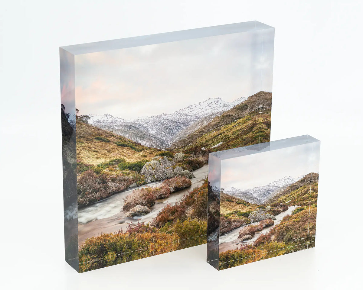 Looking Up acrylic blocks in different sizes displayed on a desk. 