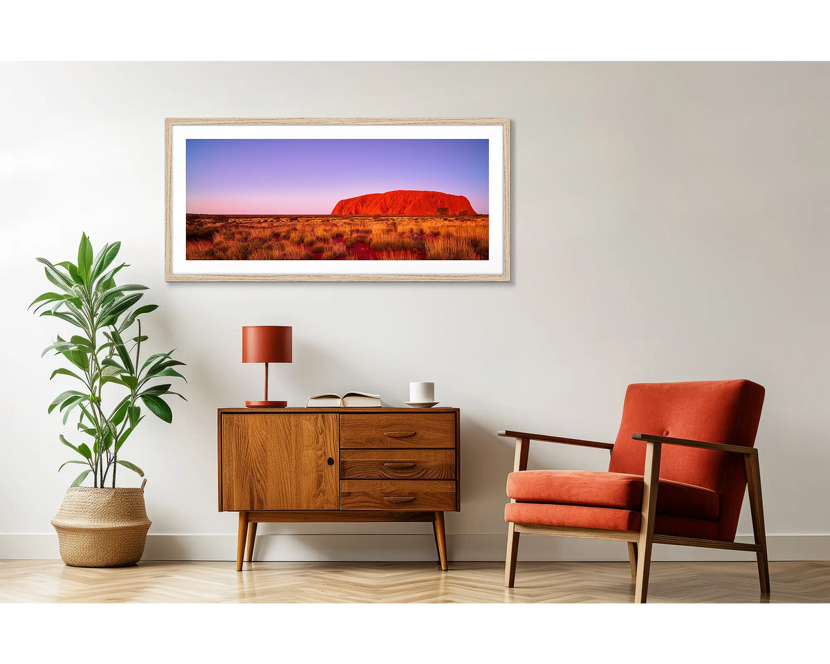 Majestic Uluru.  Framed outback wall art, hanging on a wall above a side table. 