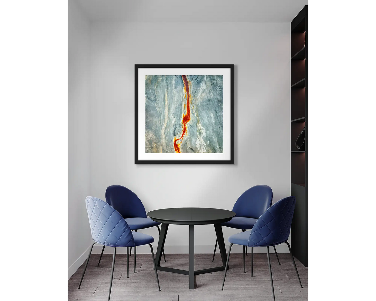 Median. Aerial abstract, wall art print, with a black frame, in an office meeting room.